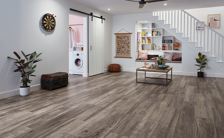 basement with laundry room and dark laminate flooring